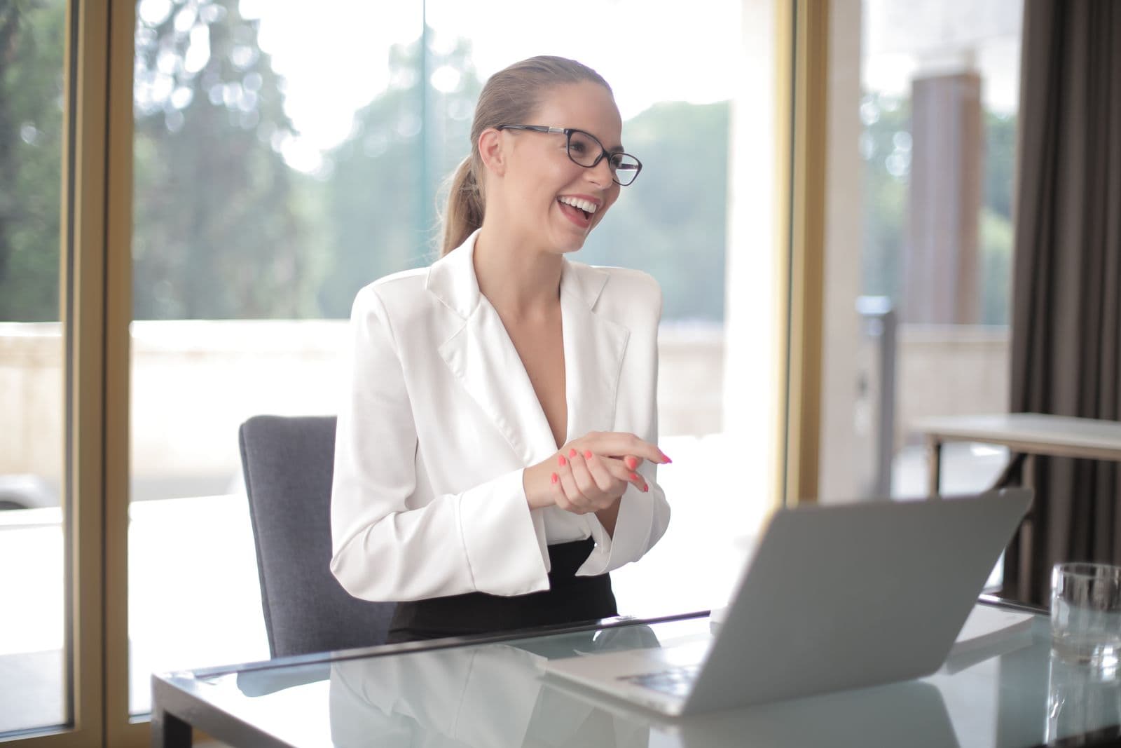 A product manager smiling while working on her laptop